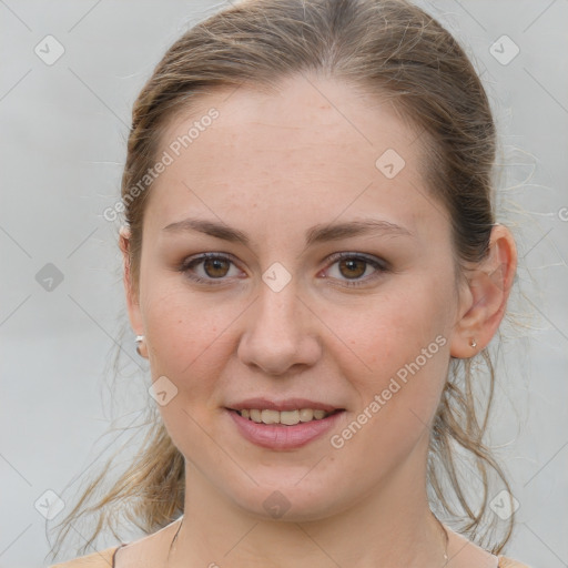 Joyful white young-adult female with medium  brown hair and grey eyes