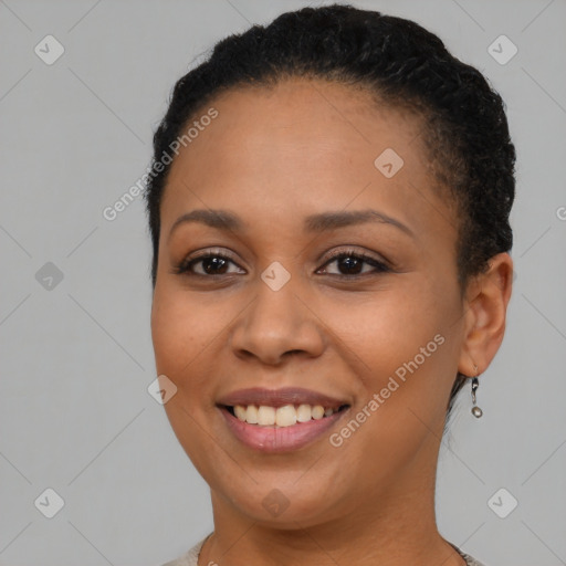 Joyful black young-adult female with short  brown hair and brown eyes