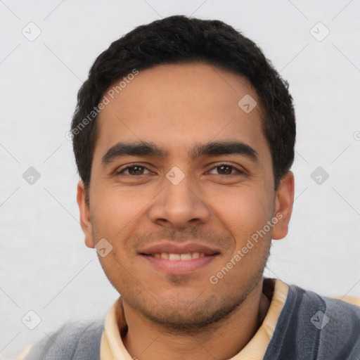 Joyful latino young-adult male with short  black hair and brown eyes