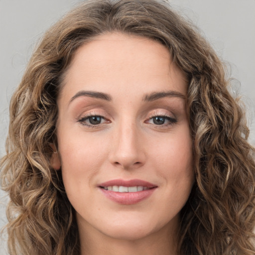 Joyful white young-adult female with long  brown hair and green eyes