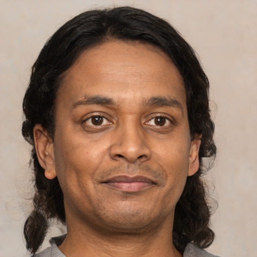 Neutral latino adult male with medium  brown hair and brown eyes