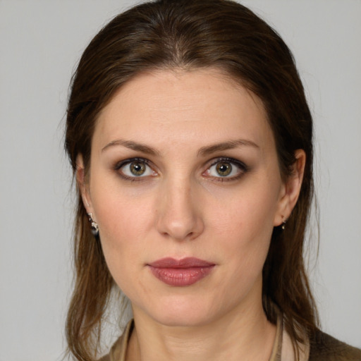 Joyful white young-adult female with medium  brown hair and green eyes