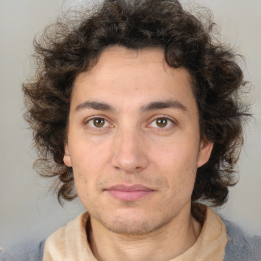 Joyful white young-adult male with medium  brown hair and brown eyes