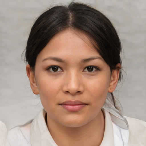 Joyful asian young-adult female with medium  brown hair and brown eyes