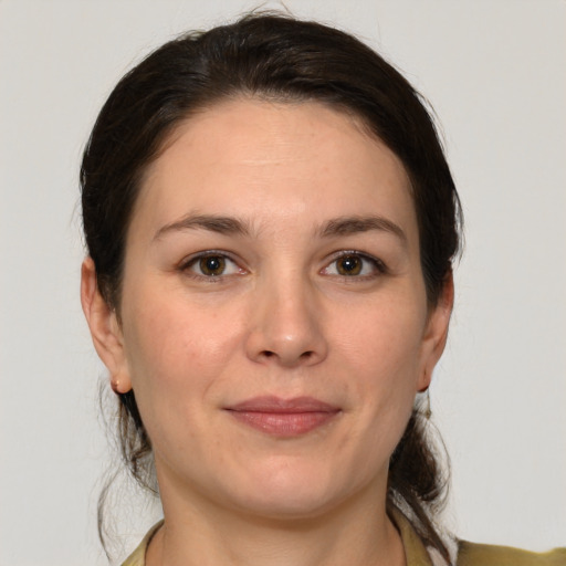 Joyful white adult female with medium  brown hair and brown eyes