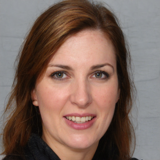 Joyful white young-adult female with medium  brown hair and blue eyes