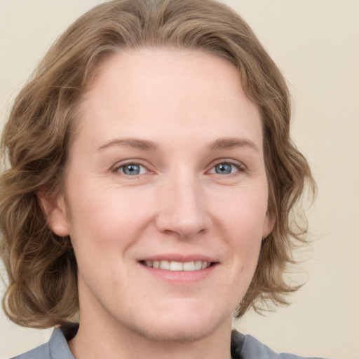 Joyful white young-adult female with medium  brown hair and blue eyes