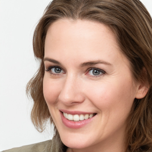 Joyful white young-adult female with long  brown hair and green eyes