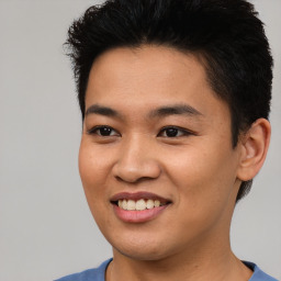 Joyful asian young-adult male with short  black hair and brown eyes