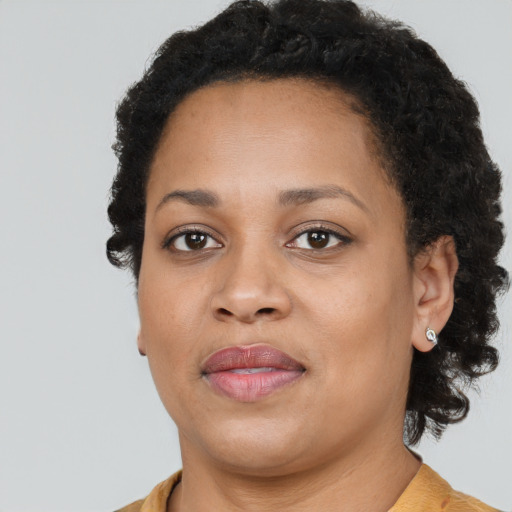 Joyful black young-adult female with medium  brown hair and brown eyes
