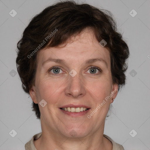 Joyful white adult female with short  brown hair and grey eyes