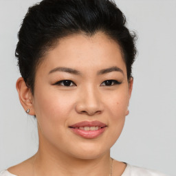 Joyful asian young-adult female with short  brown hair and brown eyes