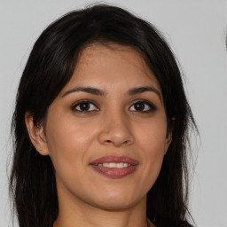 Joyful white young-adult female with long  brown hair and brown eyes