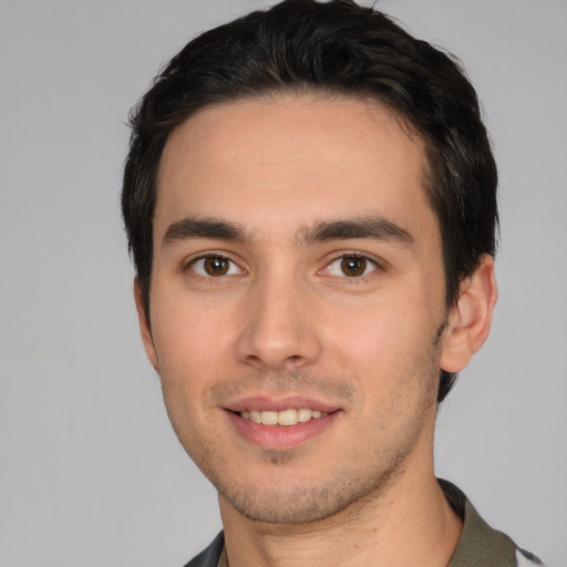 Joyful white young-adult male with short  black hair and brown eyes