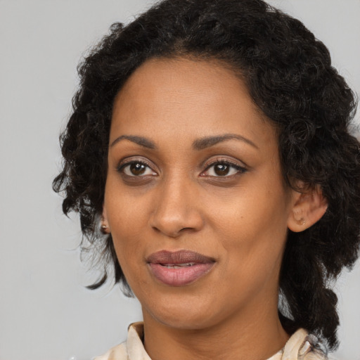 Joyful black adult female with medium  black hair and brown eyes