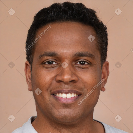 Joyful latino young-adult male with short  brown hair and brown eyes