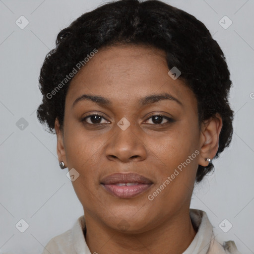 Joyful black adult female with short  brown hair and brown eyes