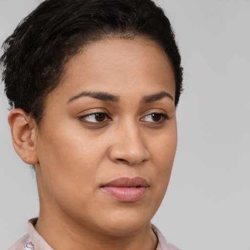 Joyful latino young-adult female with short  brown hair and brown eyes