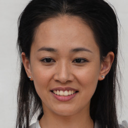 Joyful black young-adult female with long  brown hair and brown eyes