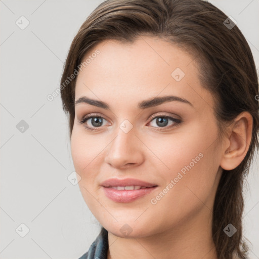 Joyful white young-adult female with long  brown hair and grey eyes