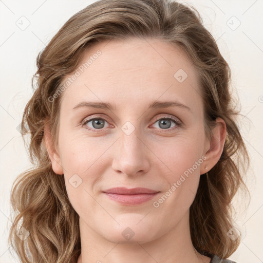 Joyful white young-adult female with medium  brown hair and blue eyes