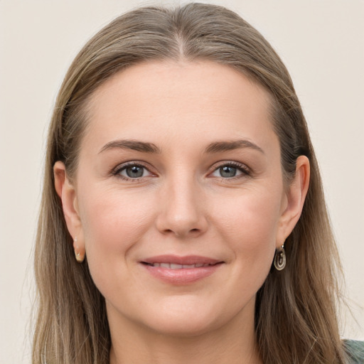 Joyful white young-adult female with long  brown hair and grey eyes