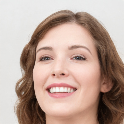 Joyful white young-adult female with long  brown hair and green eyes