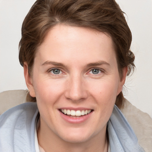 Joyful white young-adult female with medium  brown hair and blue eyes