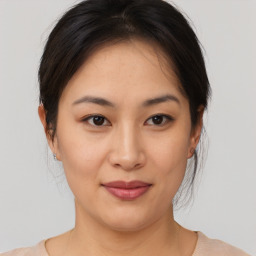 Joyful asian young-adult female with medium  brown hair and brown eyes