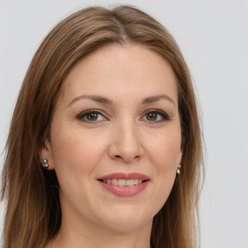 Joyful white young-adult female with long  brown hair and green eyes