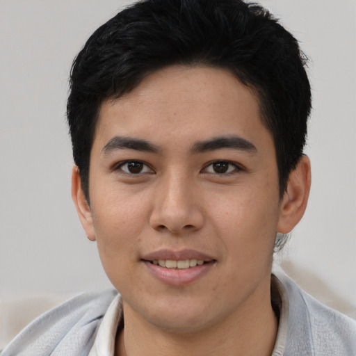Joyful asian young-adult male with short  black hair and brown eyes
