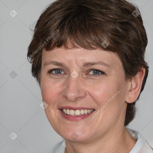 Joyful white adult female with medium  brown hair and grey eyes