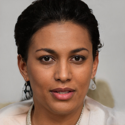 Joyful black young-adult female with short  brown hair and brown eyes