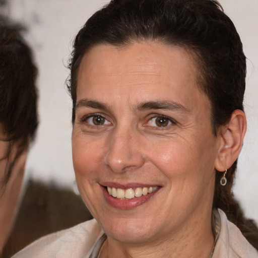 Joyful white adult female with short  brown hair and brown eyes