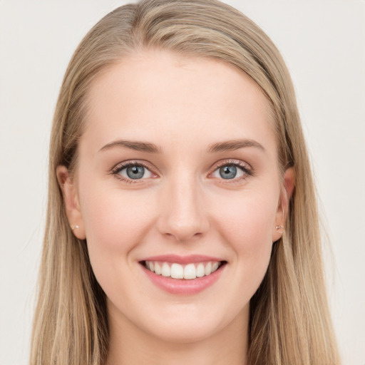 Joyful white young-adult female with long  brown hair and blue eyes