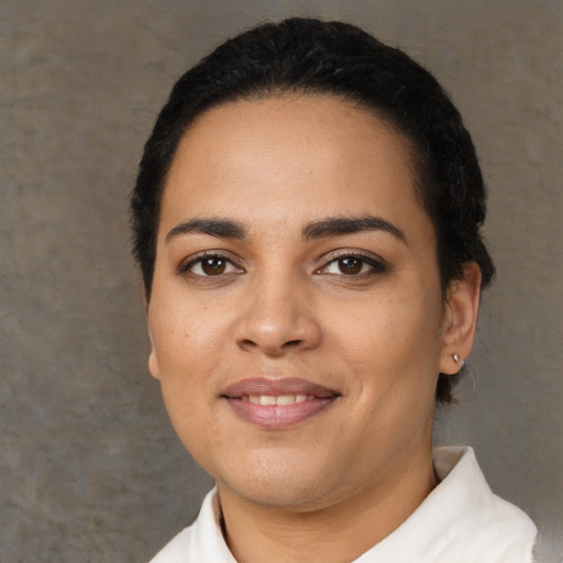 Joyful latino young-adult female with short  black hair and brown eyes
