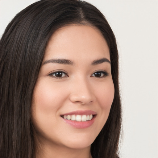 Joyful white young-adult female with long  brown hair and brown eyes