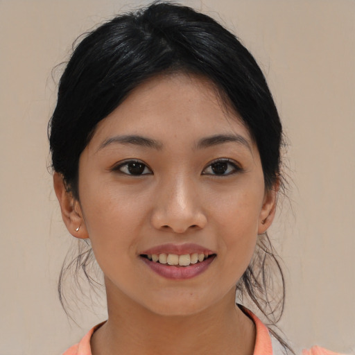 Joyful asian young-adult female with medium  black hair and brown eyes