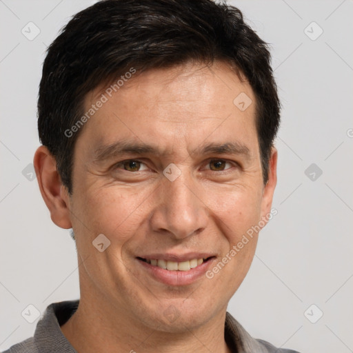 Joyful white adult male with short  brown hair and brown eyes