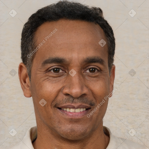 Joyful black adult male with short  brown hair and brown eyes