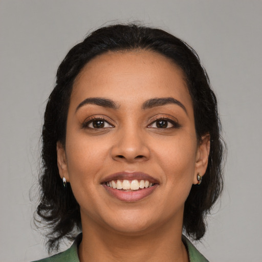 Joyful latino young-adult female with medium  black hair and brown eyes