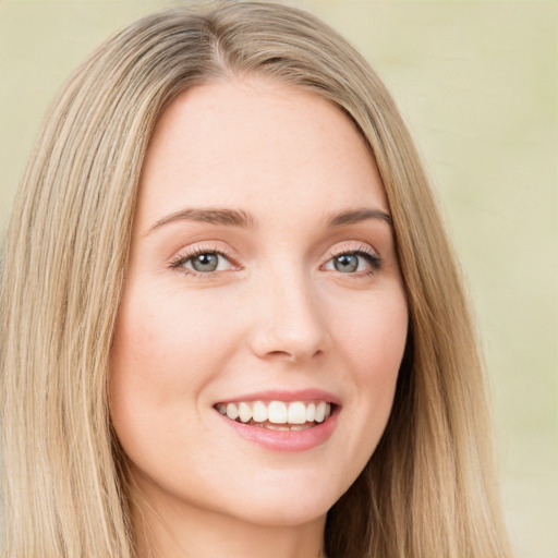 Joyful white young-adult female with long  brown hair and green eyes