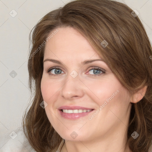 Joyful white adult female with medium  brown hair and blue eyes