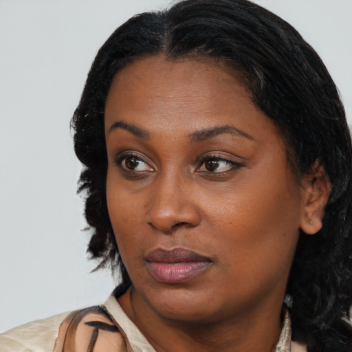 Neutral black young-adult female with medium  brown hair and brown eyes