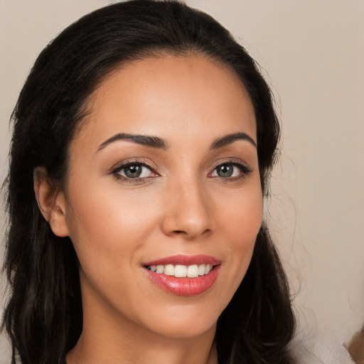 Joyful white young-adult female with long  brown hair and brown eyes