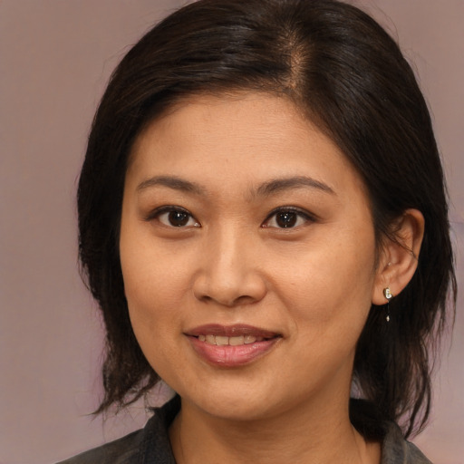 Joyful asian young-adult female with medium  brown hair and brown eyes