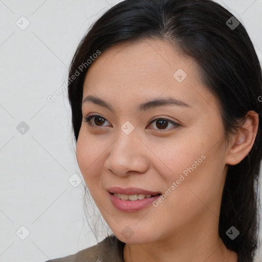 Joyful asian young-adult female with long  brown hair and brown eyes