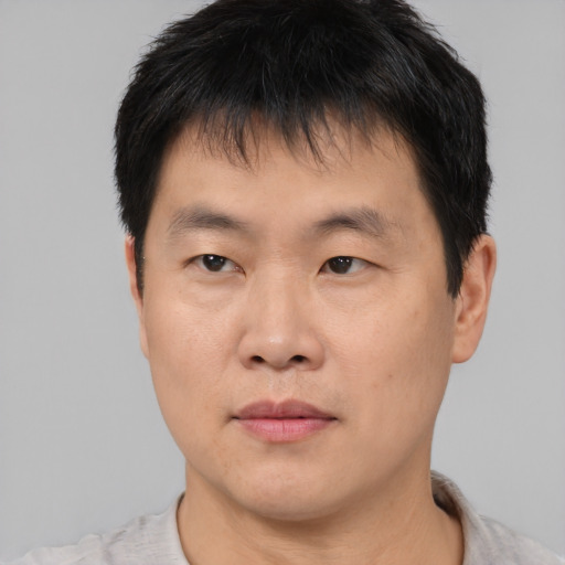Neutral asian young-adult male with short  brown hair and brown eyes