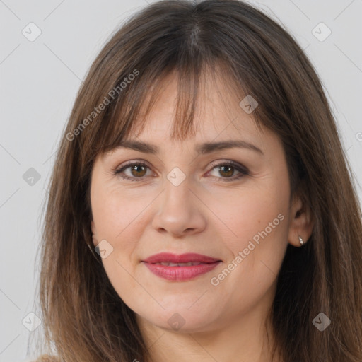 Joyful white adult female with long  brown hair and brown eyes