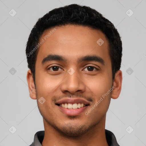 Joyful latino young-adult male with short  black hair and brown eyes